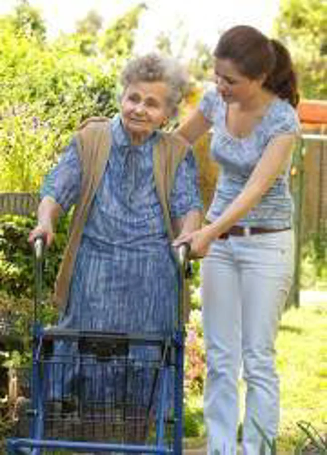 caregiver and senior in yard caregiver and senior in yard
